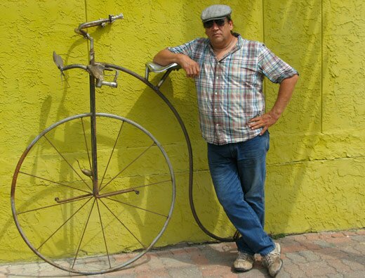 Daniel Saldaña standing with his newest art bike